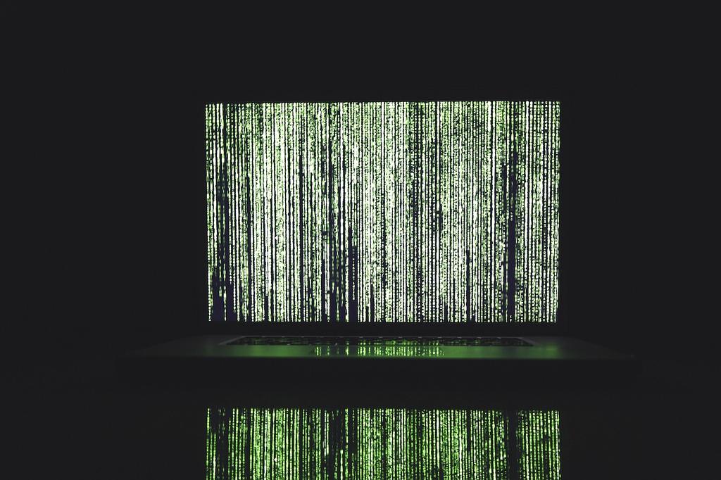 IT professional performing backup monitoring on multiple screens